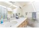 Bright bathroom features a double vanity, skylight, and a large mirror at 461 Fillmore St, Denver, CO 80206
