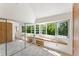 Bright bedroom with large windows, built-in seating, closet and views of lush greenery at 461 Fillmore St, Denver, CO 80206
