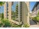 Modern condo building exterior with large windows, lush landscaping and neighborhood views at 461 Fillmore St, Denver, CO 80206