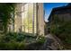 Modern building with large glass window feature and lush landscaping at dusk at 461 Fillmore St, Denver, CO 80206