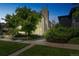Modern home with large window features, mature tree, and manicured lawn at 461 Fillmore St, Denver, CO 80206
