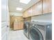 Spacious laundry room featuring granite countertops, ample storage, and modern washer/dryer units at 461 Fillmore St, Denver, CO 80206
