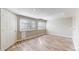 Versatile basement space featuring hardwood flooring, natural light, and a private entrance, ideal for various uses at 5308 S Ukraine St, Aurora, CO 80015