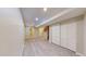 Open basement features wood floors, neutral paint and ample lighting, ready to be transformed into additional living space at 5308 S Ukraine St, Aurora, CO 80015