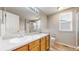 Bright bathroom with double sink vanity, large mirror, and a separate shower and toilet area at 5308 S Ukraine St, Aurora, CO 80015