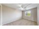 Cozy bedroom with carpet, neutral walls, and natural light from the window, complemented by a ceiling fan at 5308 S Ukraine St, Aurora, CO 80015