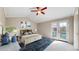 Cozy bedroom features a vaulted ceiling, a ceiling fan, and access to a private balcony through glass doors at 5308 S Ukraine St, Aurora, CO 80015