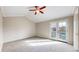 Bright bedroom featuring a vaulted ceiling, a ceiling fan, and access to a private balcony through glass doors at 5308 S Ukraine St, Aurora, CO 80015