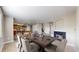 Elegant dining area adjacent to the kitchen, featuring a fireplace and comfortable seating at 5308 S Ukraine St, Aurora, CO 80015