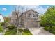 Charming two-story home with a well-maintained lawn, mature trees, and a two-car garage during the day at 5308 S Ukraine St, Aurora, CO 80015