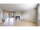 Spacious living area with a fireplace, neutral walls, and tile flooring at 5308 S Ukraine St, Aurora, CO 80015