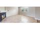 Bright, tiled living room with a modern fireplace and ample natural light at 5308 S Ukraine St, Aurora, CO 80015