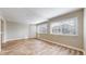 Bright living room features wood floors, neutral paint, and large windows, perfect for entertaining and relaxing at 5308 S Ukraine St, Aurora, CO 80015