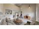 Bright and airy living room with a vaulted ceiling, neutral color palette, and tile flooring at 5308 S Ukraine St, Aurora, CO 80015
