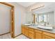 Bathroom featuring double sinks, ample counter space, and a large mirror at 16478 Marion St, Thornton, CO 80602