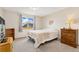 Comfortable bedroom with neutral tones, plush carpet, and a classic wooden dresser for storage at 16478 Marion St, Thornton, CO 80602