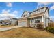 Charming two-story home featuring a brick facade, covered porch, and attached two-car garage at 16478 Marion St, Thornton, CO 80602