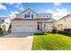 Charming two-story home with brick accents, a two-car garage, and a welcoming front porch at 16478 Marion St, Thornton, CO 80602
