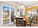 Eat-in kitchen features stainless steel appliances and sliding glass doors to the backyard at 16478 Marion St, Thornton, CO 80602