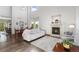 Bright living room with a fireplace, hardwood floors, and high ceilings at 16478 Marion St, Thornton, CO 80602