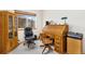 Home office with a large window, vintage rolltop desk and plenty of natural light at 16478 Marion St, Thornton, CO 80602