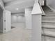 Finished basement area with gray carpet, access to stairs, and utility room at 368 Dallas St, Denver, CO 80230