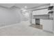 Basement kitchenette with gray countertops, tile flooring, and a stainless steel sink at 368 Dallas St, Denver, CO 80230