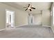 Spacious bedroom with neutral carpet, ceiling fan, closet and ensuite bathroom at 368 Dallas St, Denver, CO 80230