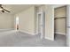 Spacious bedroom with neutral carpet, ceiling fan, closet and ensuite bathroom at 368 Dallas St, Denver, CO 80230