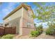 Side view of a two-story home with stone landscaping and lush trees surrounding the perimeter at 368 Dallas St, Denver, CO 80230
