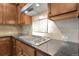 Kitchen close-up showcasing the gas range, backsplash tile and stainless steel vent, adding to functionality at 368 Dallas St, Denver, CO 80230