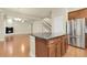 Open kitchen boasts stainless appliances, island, hardwood floors, and seamless flow into the living area at 368 Dallas St, Denver, CO 80230