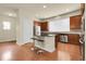 Spacious kitchen with stainless steel appliances, central island with barstool seating, and abundant cabinet space at 368 Dallas St, Denver, CO 80230