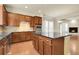Gourmet kitchen with cherry cabinets, granite countertops, and stainless steel appliances and island at 368 Dallas St, Denver, CO 80230