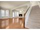 Open-concept living room featuring hardwood floors, fireplace and staircase with neutral color scheme at 368 Dallas St, Denver, CO 80230