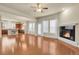 Inviting living room with hardwood floors, a fireplace, and an open layout connected to the kitchen at 368 Dallas St, Denver, CO 80230