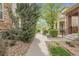 Sidewalk view towards property showcasing landscaped areas on either side, stone and greenery at 368 Dallas St, Denver, CO 80230
