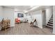 Finished basement with stylish seating area and durable vinyl plank flooring at 5008 Alcott St, Denver, CO 80221