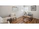 Charming bedroom area with bright window, modern desk, chair, and accent seating at 5008 Alcott St, Denver, CO 80221
