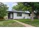 Charming single-story home with stone accents and a well-maintained lawn, nestled in a quiet neighborhood setting at 5008 Alcott St, Denver, CO 80221