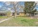 Charming yellow house with mature landscaping and green front lawn at 5008 Alcott St, Denver, CO 80221