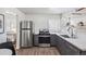 Well-lit kitchen features stainless steel appliances, lots of natural light, and stylish cabinetry at 5008 Alcott St, Denver, CO 80221