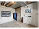 Unfinished laundry room featuring a washer, concrete walls and floor, and a 'Laundry Room' sign at 5008 Alcott St, Denver, CO 80221