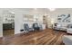 Open-concept living room features hardwood floors, neutral tones, and a view into the kitchen at 5008 Alcott St, Denver, CO 80221