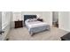 Serene bedroom features a tufted headboard, soft lighting, and ensuite bathroom at 5861 Tesoro Pt, Parker, CO 80134