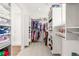 Organized walk-in closet with ample shelving, hanging space, and a view into the bathroom at 5861 Tesoro Pt, Parker, CO 80134