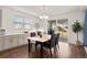 Charming dining room filled with natural light features dark wood table and view to fenced backyard at 5861 Tesoro Pt, Parker, CO 80134