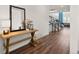 Inviting entryway with wood floors, console table with decor, and stairs leading to the second level at 5861 Tesoro Pt, Parker, CO 80134
