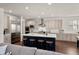 Gourmet kitchen featuring a large center island with seating, stainless steel appliances and modern cabinets at 5861 Tesoro Pt, Parker, CO 80134
