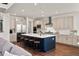 Modern kitchen with stainless steel appliances, a large island with seating, and plenty of counter space at 5861 Tesoro Pt, Parker, CO 80134